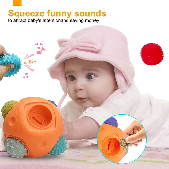 A baby in a pink hat lies on their stomach, playing with the Toyfetti Montessori Sensory Wonder Ball—an educational textured ball set for babies. An adult squeezes it for funny sounds while another helps develop fine motor skills with coin insertion.