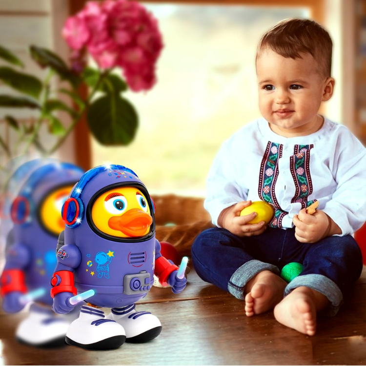 A baby in a traditional embroidered shirt sits barefoot on a wooden floor, holding a yellow egg, next to the Toyfetti DazzleDuck – Light-Up Musical Dancing Duck with vibrant lights and musical sounds. A blurred duplicate of the toy appears in the foreground.