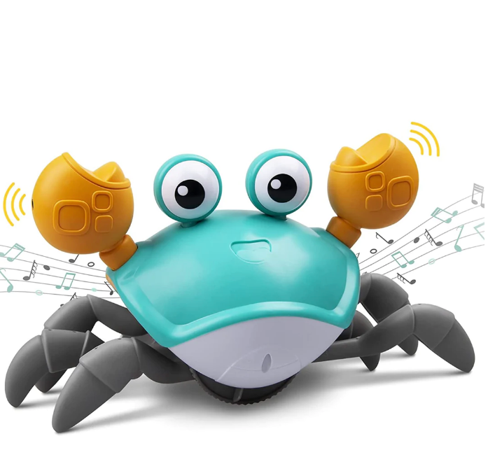 The Toyfetti HappyCrab – Crawling Companion with Lights & Music features a cute, cartoon design with big eyes, orange claws, and gray legs. It moves on its own, plays music for tummy time, and displays floating musical notes in the background.