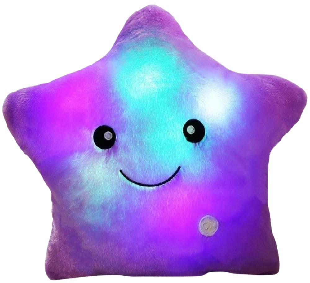 The Toyfetti GlowPals Light-Up Plush Night Buddy is a star-shaped pillow with a smiling face and glowing purple, blue, and white lights—perfect as a cozy bedtime companion or soothing night light for kids.
