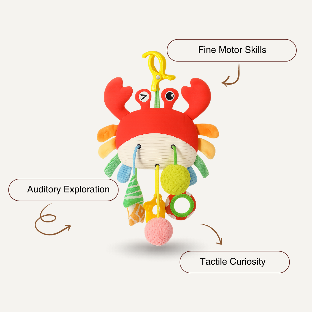 The Toyfetti Crabby Clip-On Sensory Toy is a colorful hanging baby activity plush with rattles and textures to support fine motor skills, tactile curiosity, and auditory play. It features a yellow clip for easy attachment to cribs or strollers.