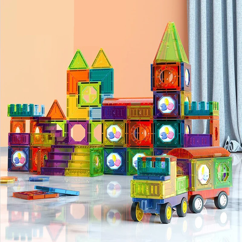 Toyfettis BrightTracks Magnetic Marble Run – Build, Click, Light Up! forms a dazzling castle with towers and walls near an orange wall, inspiring endless STEM creativity and adventure for young builders.
