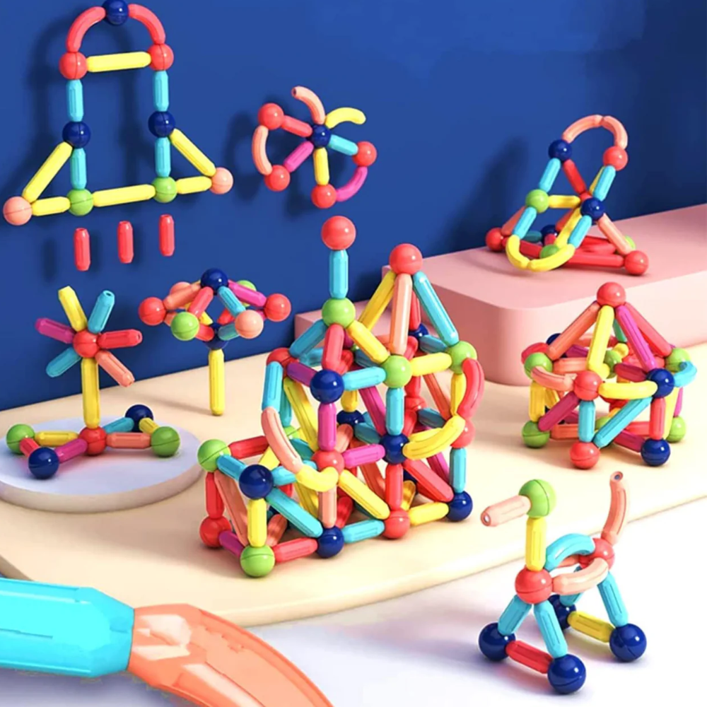 MagniBlocks™- The OG Magnetic Building Blocks by Toyfetti are assembled into rockets, flowers, and abstract designs using colorful magnetic sticks and balls, displayed on a light surface with a blue background.