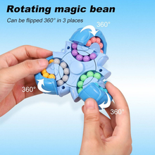 A person holds the Toyfetti BrainBounce Rotating Logic Spinner – 2-in-1 Focus Toy & Puzzle Game, a blue sensory toy with colorful beads in three circular tracks. Arrows show it can rotate 360° in three spots. Text above highlights its unique fidget movement.