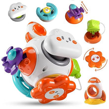 The Toyfetti Montessori Sensory Activity Cube – Press, Turn & Explore Learning Toy for Toddlers features a central round white toy with smiling cloud and flower faces, plus detachable gears and shapes for sensory play. Additional small toys included.