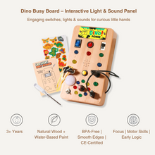 The Toyfetti Dino Busy Board – Interactive Light & Sound Activity Panel features colorful switches, lights, buttons, cords, and a dino sticker sheet. Made from natural wood and BPA-free materials to encourage logic and fine motor skills.