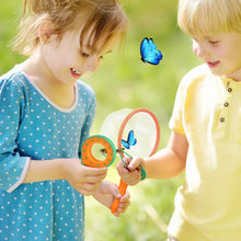 Two young junior scientists smile as they use the Toyfetti Little Explorer Bug Catching Set—Nature Discovery Kit for Curious Kids—to observe a blue butterfly with the included magnifying glass and net on a sunny day outdoors.