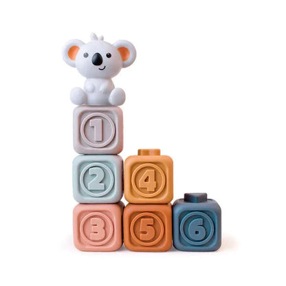 The Toyfetti CubbyKoala – Soft Silicone Teether & Stacking Toy Set for Babies features pastel blocks numbered 1–6 stacked with a cute koala figurine on top, shown against a white background.