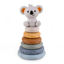 The Toyfetti CubbyKoala – Soft Silicone Teether & Stacking Toy Set for Babies features a gray koala atop four textured rings in yellow, brown, blue, and gray—ideal as both a stacking toy and teether.