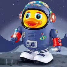 The Toyfetti DazzleDuck is a yellow cartoon duck in a blue spacesuit with red gloves and shoes, standing on a lunar surface under a starry sky. The suit lights up with vibrant effects and plays music like a fun toddler dancing toy.