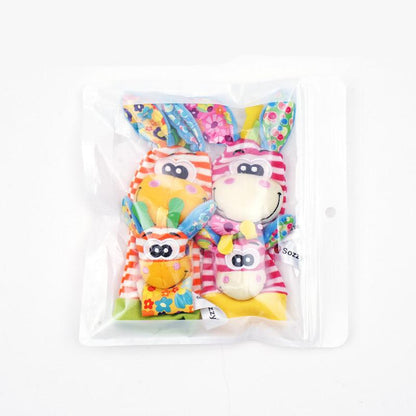 The Toyfetti Plush Animal Baby Socks & Wrist Rattle Set features striped, colorful rattles with animal faces and long ears, packaged with plush socks in a clear resealable bag for sensory play, shown on a white background.