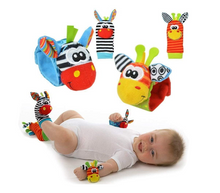 A baby wears the Toyfetti Plush Animal Baby Socks & Wrist Rattle Set – Sensory Play for Little Explorers, shown with zebra and giraffe rattles for hands and feet, making engaging sensory toys.
