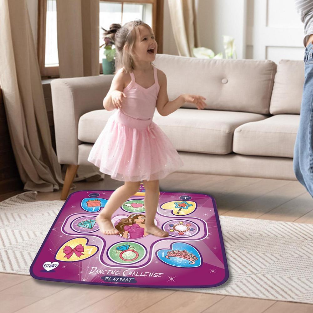 A young girl in a pink tutu dances joyfully on the Toyfetti Interactive Dance Light Mat – LED Movement Game for Kids in the living room, smiling with arms raised. The mat has dance illustrations, built-in music, and fun rhythm-game functions.