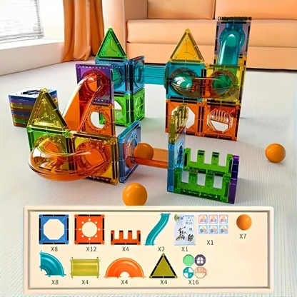 The Toyfetti BrightTracks Magnetic Marble Run – Build, Click, Light Up! is set up on a light floor with orange balls close by. Below, an inventory lists the set’s marble run pieces, slides, and accessories, each labeled with quantities.