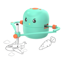 The Toyfetti ArtBot – Interactive Drawing Robot for Kids is a teal, cartoon-like robot with a smiling face that uses its attached pen to sketch black-and-white outlines, like an airplane and a carrot, making step-by-step creative learning fun.