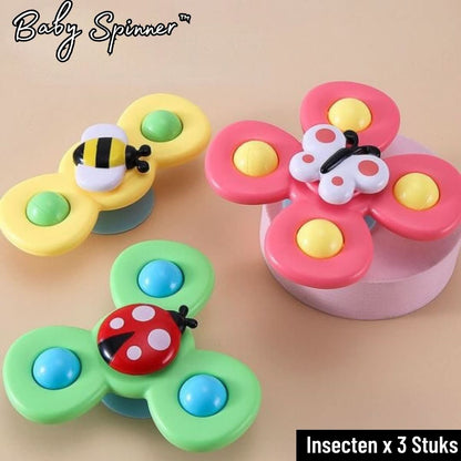 Three Toyfetti Whirlie Baby Spinners, shaped like a bee, butterfly, and ladybug, sit on a light surface. These bright sensory spin toys encourage fine motor skills. The image shows Baby Spinner and Insecten x 3 Stuks.