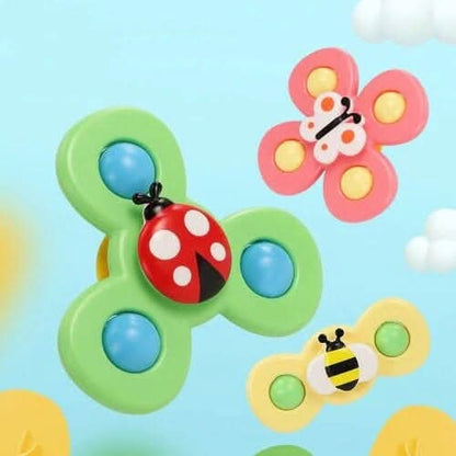 Toyfettis Whirlie Baby Spinner – Sensory Spin Toy for Fine Motor Fun features three colorful spinners shaped like a ladybug, butterfly, and bee on a light blue background, perfect for sensory development or as a fun baby travel toy.