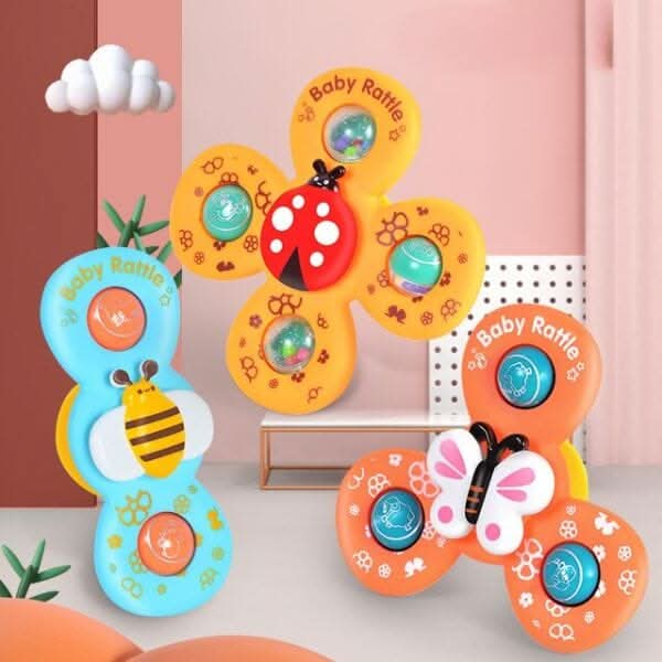 The Toyfetti Whirlie Baby Spinner is a sensory spin toy with animal designs (bee, ladybug, butterfly) that encourages fine motor development in pastel-themed nurseries with pink walls, a cozy chair, and decorative plants.