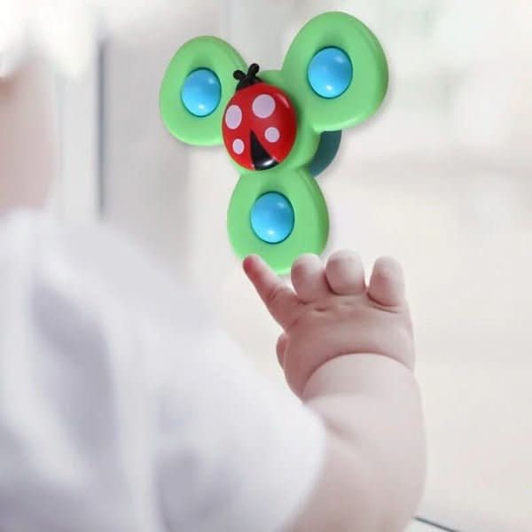 The Toyfetti Whirlie Baby Spinner is a sensory spin toy featuring blue buttons and a red ladybug design, suctions to windows, and is perfect as a baby travel toy for fine motor development.
