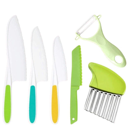 The Toyfetti Junior Chef Kids Cooking Set features Montessori-inspired, child-safe kitchen tools: three white knives with colored handles, a green serrated knife, a white and green peeler, and a green crinkle cutter for learning through play.