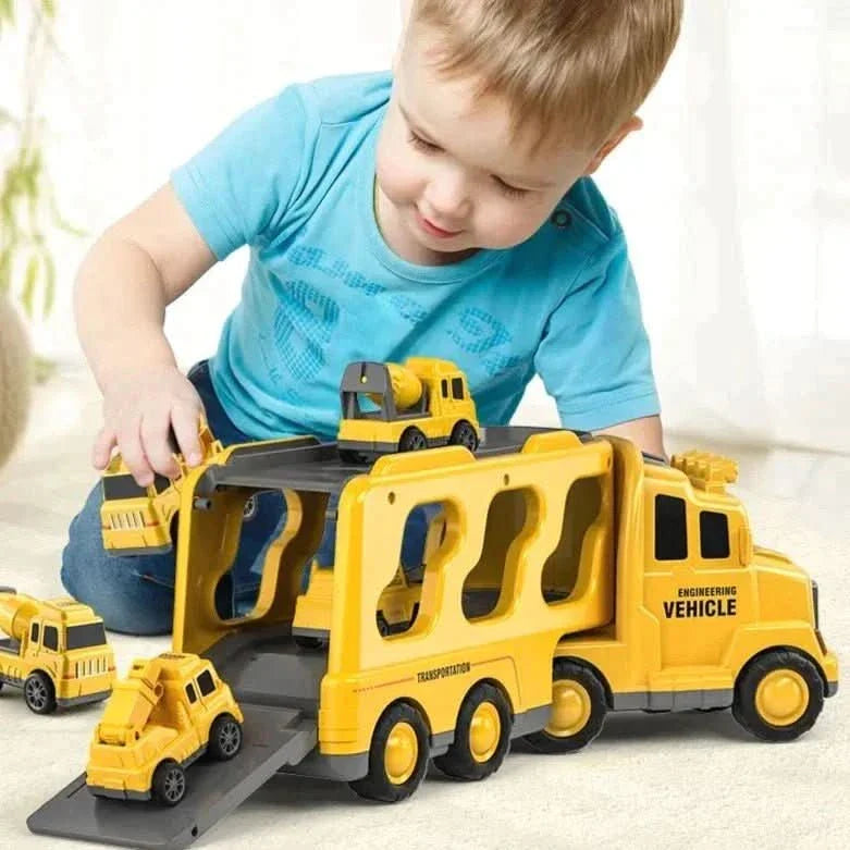 A young child in a blue shirt plays with the Toyfetti MightyTrucks Builder Set, loading and unloading mini construction vehicles from the transporter ramp—the perfect imaginative gift for toddlers who love trucks.