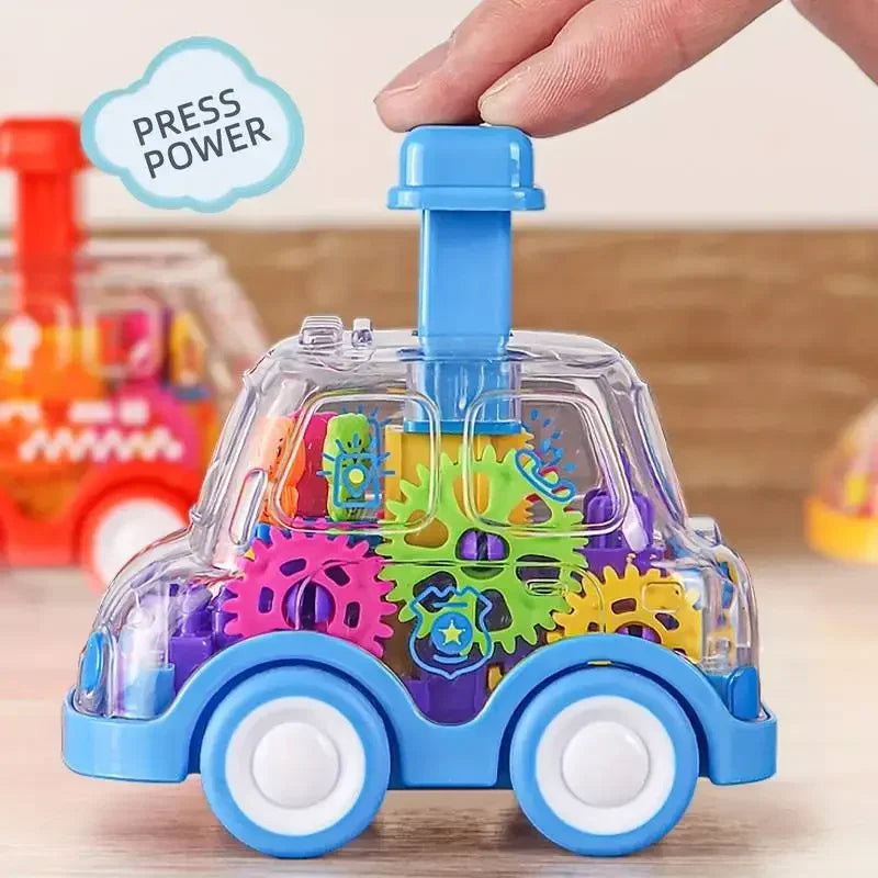 A hand presses a blue button atop the transparent Toyfetti Gear Car – Push-and-Go Friction Vehicle for Kids, filled with colorful gears and blue wheels. A PRESS POWER speech bubble appears as it sits on a wooden surface near reviews.