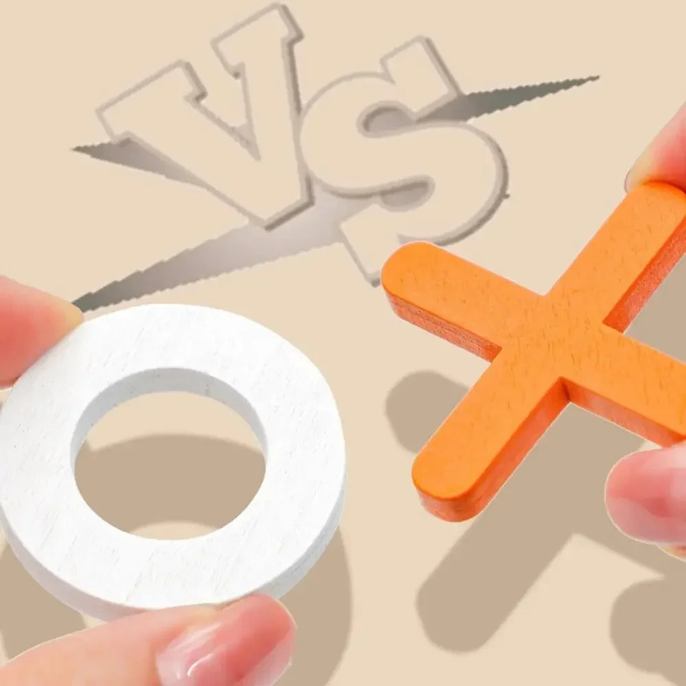 A close-up shows hands holding pieces from the Toyfetti Wooden Tic Tac Toe for Family Fun & Home Style—a white circle and an orange X—facing off with a VS in the background, perfect for game night or as a stylish home décor piece.