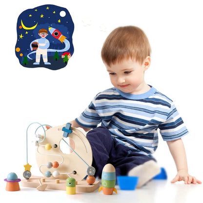 A young boy in a striped shirt plays with Toyfettis Bead Tracks – Wooden Maze Toy for Early Motor Skill Development. In the background, an illustration features an astronaut and rocket soaring through a starry night sky.