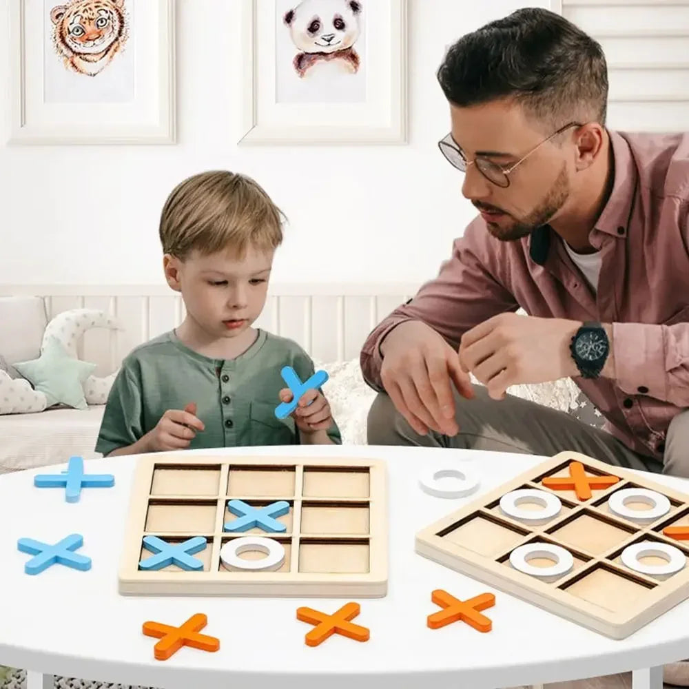 A man and boy enjoy game night with the Toyfetti Wooden Tic Tac Toe for Family Fun & Home Style. Framed animal art accents the cozy, well-lit room behind them.