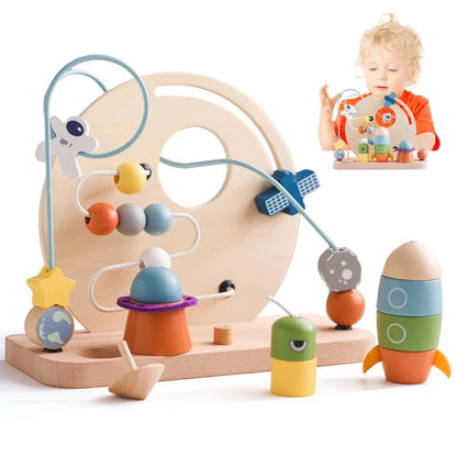 Toyfetti’s Bead Tracks – Wooden Maze Toy features a space theme with planets, rocket, and astronaut. A young child develops fine motor skills by moving beads along the wires of this engaging educational toy.