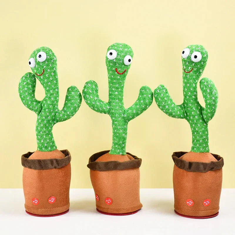 Three Toyfetti CactusBuddy – Dancing Talking Plush Toys with smiling faces, googly eyes, two arms, and green textured surfaces stand upright in brown pots against a light yellow background, keeping kids smiling and engaged.