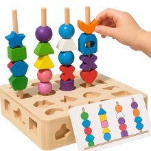 A child’s hand places a moon-shaped bead on the Toyfetti Colorful Wooden Montessori Puzzle Set for Early Skill Building, using a matching card to practice color recognition and stack the durable wooden shapes.