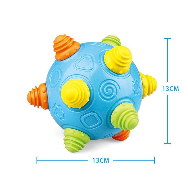 The Toyfetti Sensory Music Ball – Interactive Light & Sound Toy for Babies and Toddlers features textured nubs in yellow, green, and orange on blue, measures 13x13 cm, and is perfect for early development and sensory play.