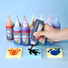 A hand squeezes black paint onto a penguin tile from Toyfettis Magic Water Wonder Kit – Create Colorful 3D Animals with Just Water. Bright Aqua Fairy paints and tiles like a yellow lobster and blue crab bring hands-on creative fun.